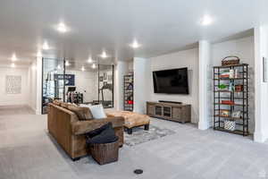 Living area featuring light colored carpet and recessed lighting