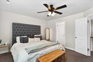 Bedroom featuring dark carpet and a ceiling fan