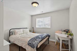 Carpeted bedroom featuring baseboards