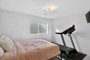 Bedroom featuring carpet flooring and baseboards