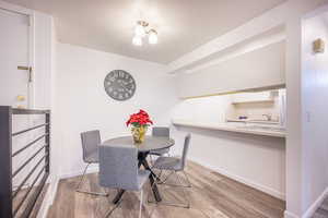Dining space with light wood-style floors and baseboards