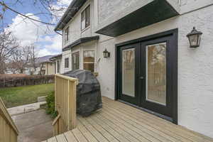 Wooden deck with french doors and area for grilling