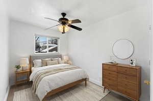 Bedroom with a ceiling fan and wood finished floors