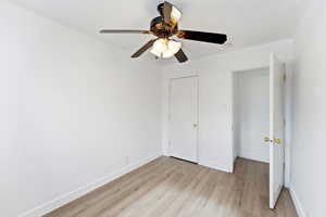 Unfurnished bedroom featuring light wood-style flooring and a ceiling fan