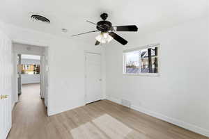 Unfurnished bedroom featuring light wood-type flooring and a ceiling fan