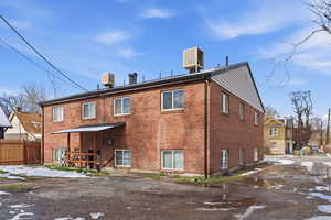 Rear view of property featuring brick siding