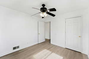 Unfurnished bedroom featuring ceiling fan and light wood-type flooring