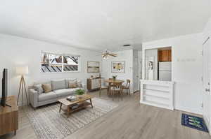 Living room featuring light wood-style floors and ceiling fan