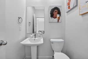 Half bath with toilet and baseboards