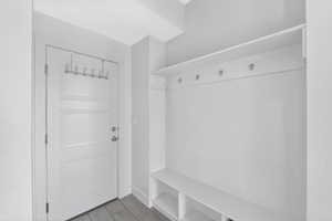 Mudroom featuring wood finished floors and baseboards