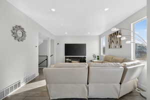 Living area featuring wood finish floors and recessed lighting