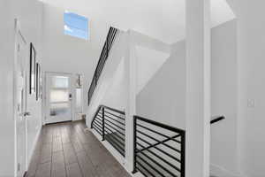 Entrance foyer with wood tiled floors and stairway
