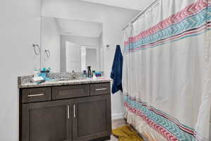 Full bath with vanity and light wood finished floors