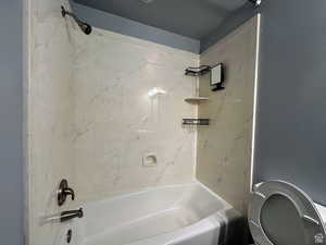 Bathroom featuring shower / bathtub combination and toilet
