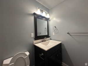 Half bath featuring vanity and toilet