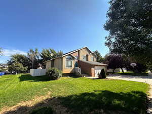View of home's exterior with concrete driveway and brick siding