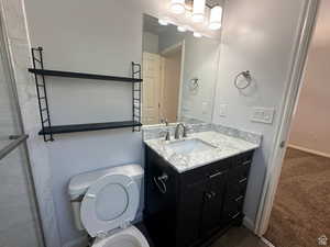 Bathroom with vanity and dark colored carpet