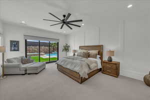 Carpeted bedroom with a decorative wall, access to outside, a ceiling fan, and recessed lighting