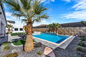 Integrated pool / spa featuring a patio and a fenced backyard