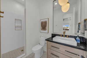 Full bath featuring vanity, walk in shower, and recessed lighting