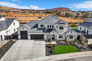 Modern inspired farmhouse with board and batten siding, driveway, a residential view, and a mountain view