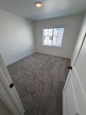 Empty room with baseboards and carpet flooring
