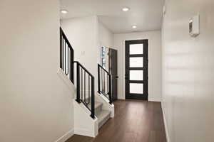 Foyer featuring dark wood finished floors and recessed lighting