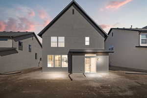 Rear view of property featuring stucco siding