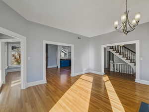 Unfurnished dining area with light wood finished floors and a chandelier