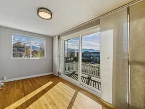 Empty room featuring a mountain view and light wood finished floors