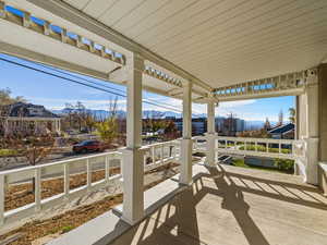 Covered porch featuring a mountain view