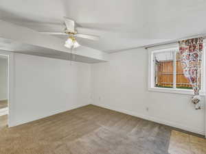 Spare room featuring ceiling fan and light carpet