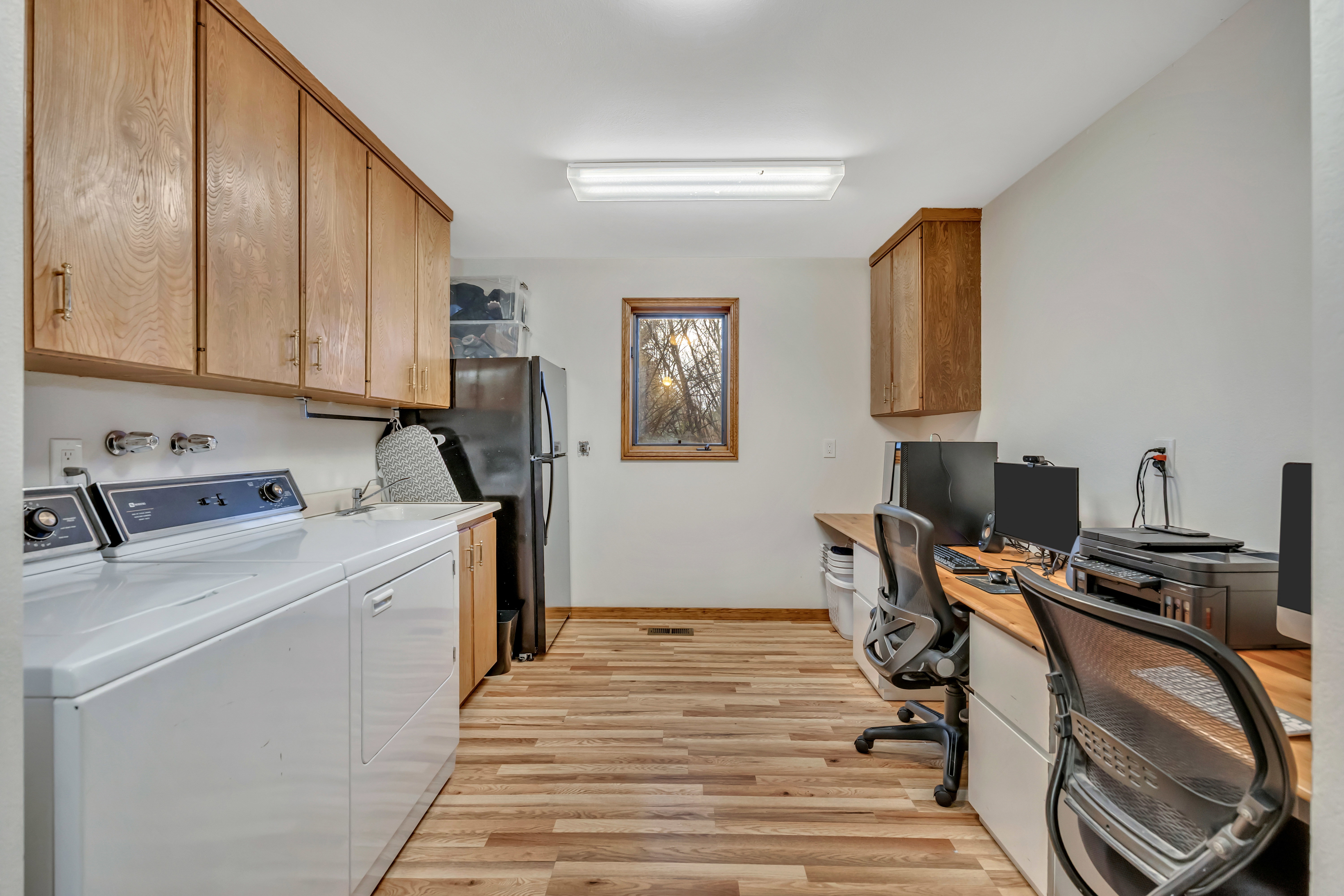 Laundry area with light wood-style floors, an office area, and washer and dryer