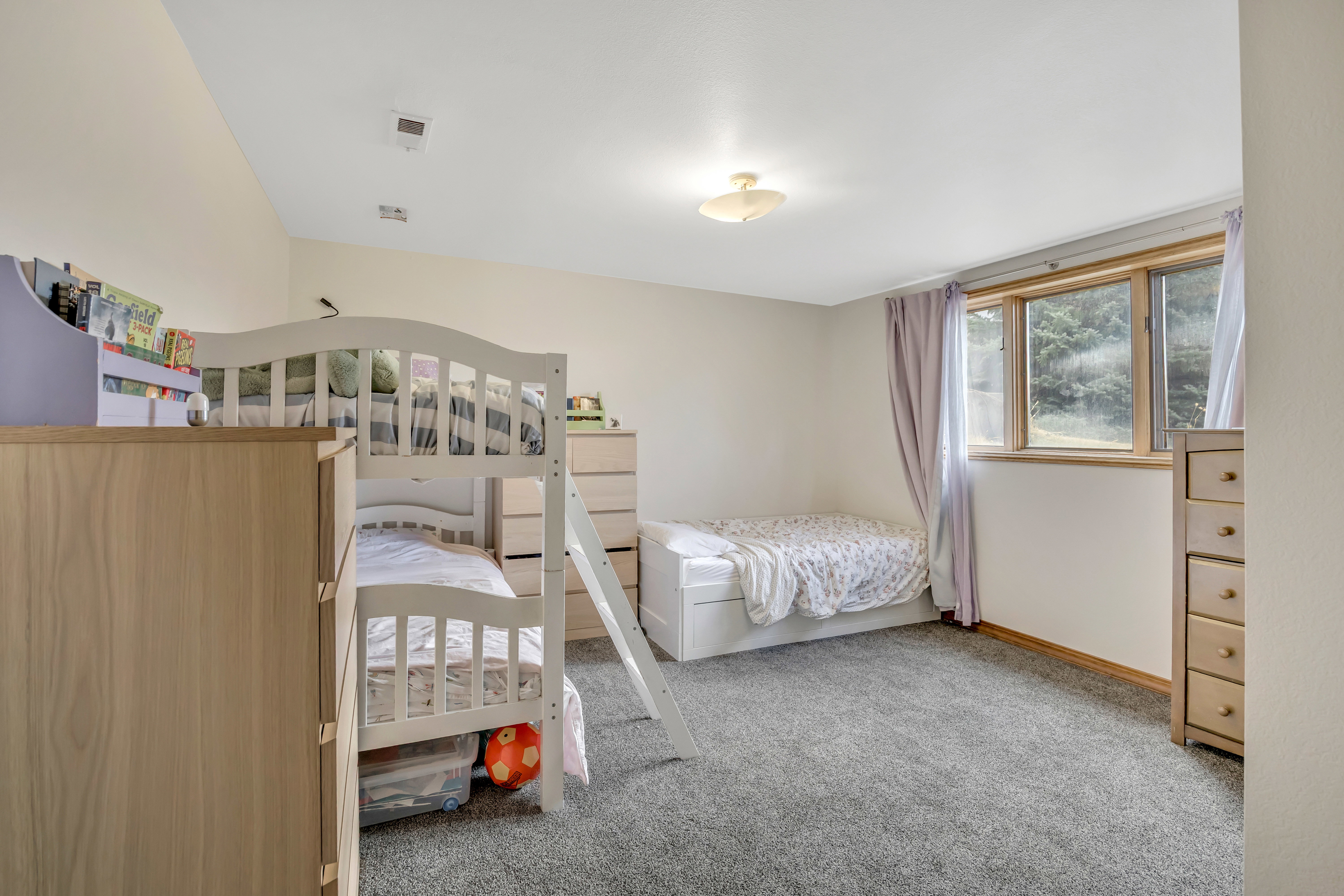 Bedroom featuring light colored carpet and baseboards