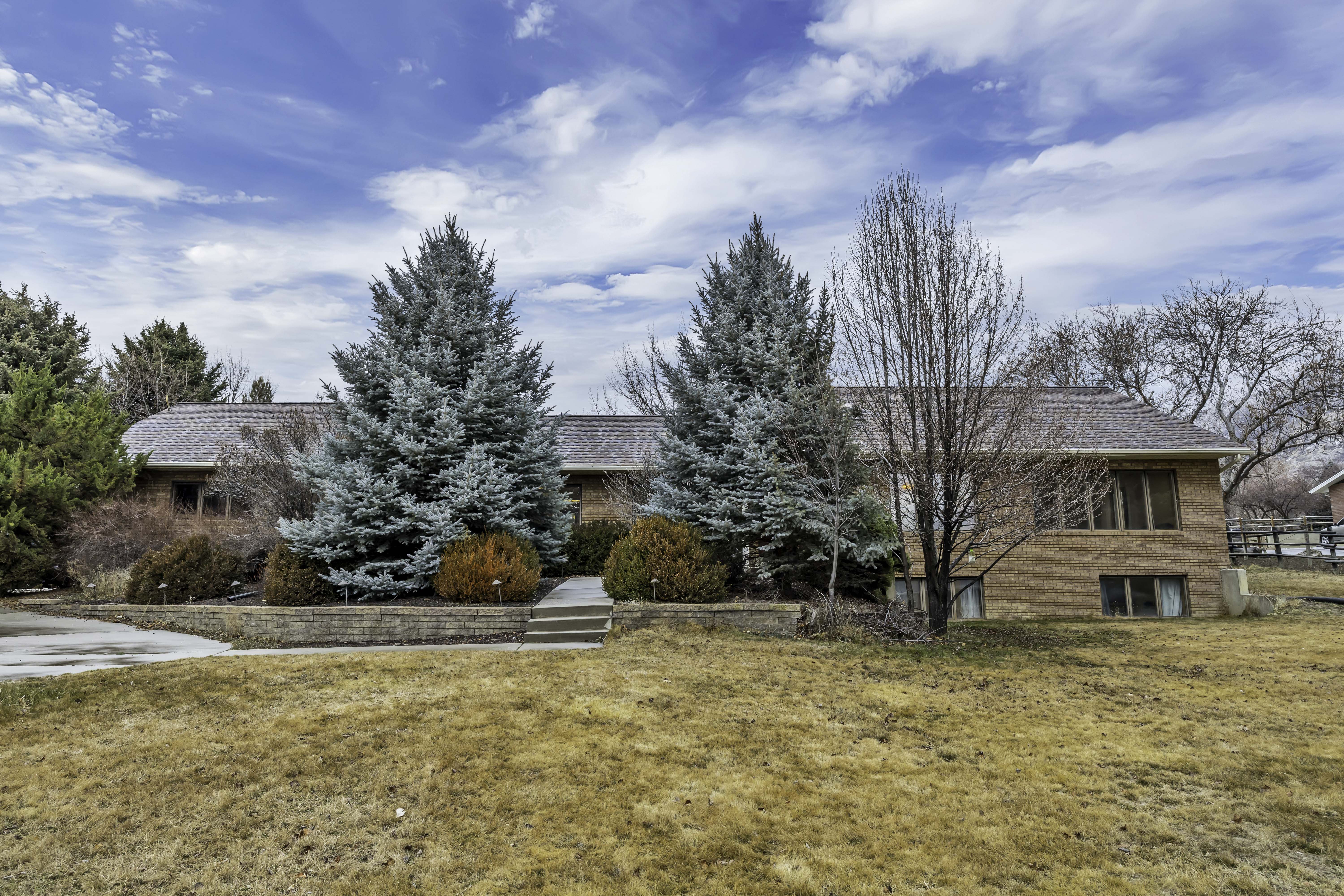View of front of property with brick siding and a front lawn