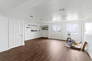 Living room with a textured ceiling and dark wood-style floors