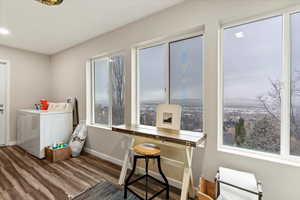 Laundry area with dark wood-type flooring and washer and dryer