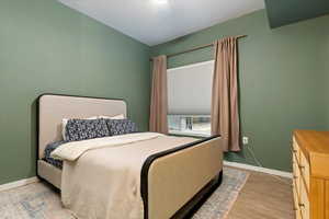 Bedroom featuring a ceiling fan and light wood-type flooring