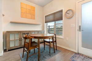 Dining area with light wood finished floors and baseboards