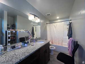 Full bathroom featuring vanity and shower / bathtub combination with curtain
