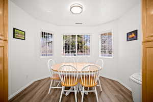 Dining area featuring wood finished floors and baseboards