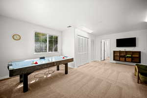 Game room featuring light colored carpet and baseboards