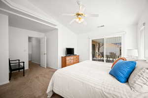 Carpeted bedroom featuring lofted ceiling, access to outside, and a ceiling fan