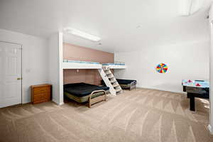 Bedroom featuring light colored carpet and baseboards