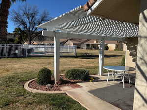 View of patio / terrace featuring a pergola and a residential view