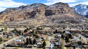 Aerial perspective of suburban area featuring a mountainous background