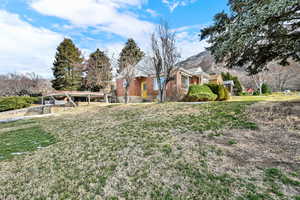 View of grassy yard with a mountain view
