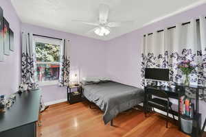 Bedroom with light wood-style flooring and ceiling fan
