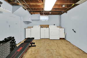 Laundry area with cabinet space and washing machine and dryer