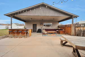View of patio / terrace featuring an outdoor lounge area with bar and area for grilling